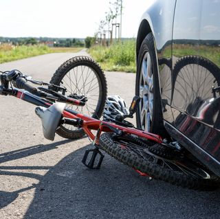 Bicycle Under Car On Road