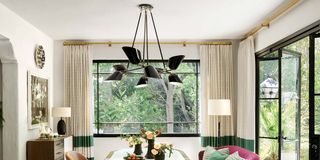 Living room with oval table with gold accents and doors leading outside